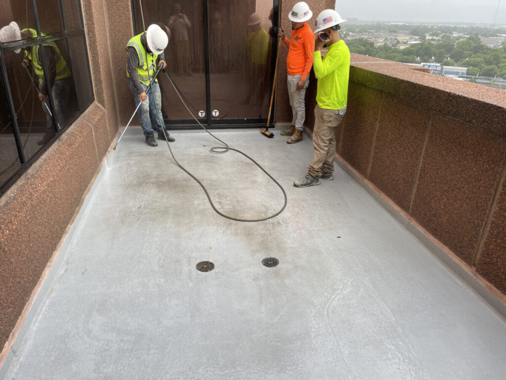 Resurfaced concrete balcony with high-solids silicone coating and ceramic granules on Arlington high-rise by Pepper Coatings