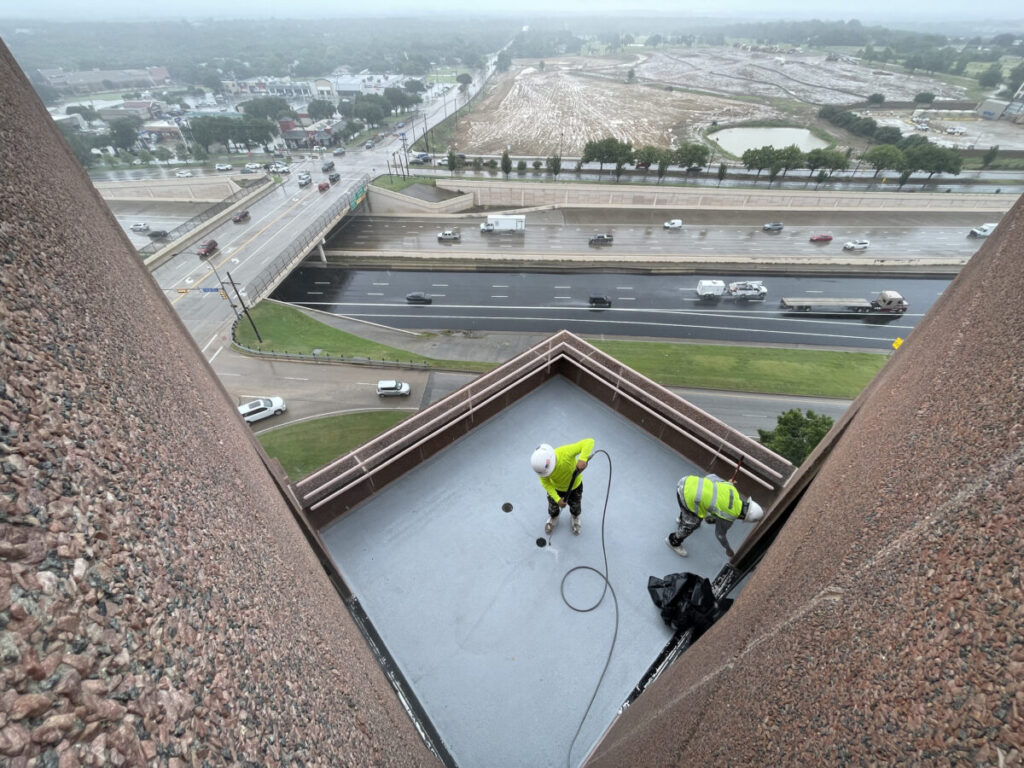 Resurfaced concrete balcony with high-solids silicone coating and ceramic granules on Arlington high-rise by Pepper Coatings
