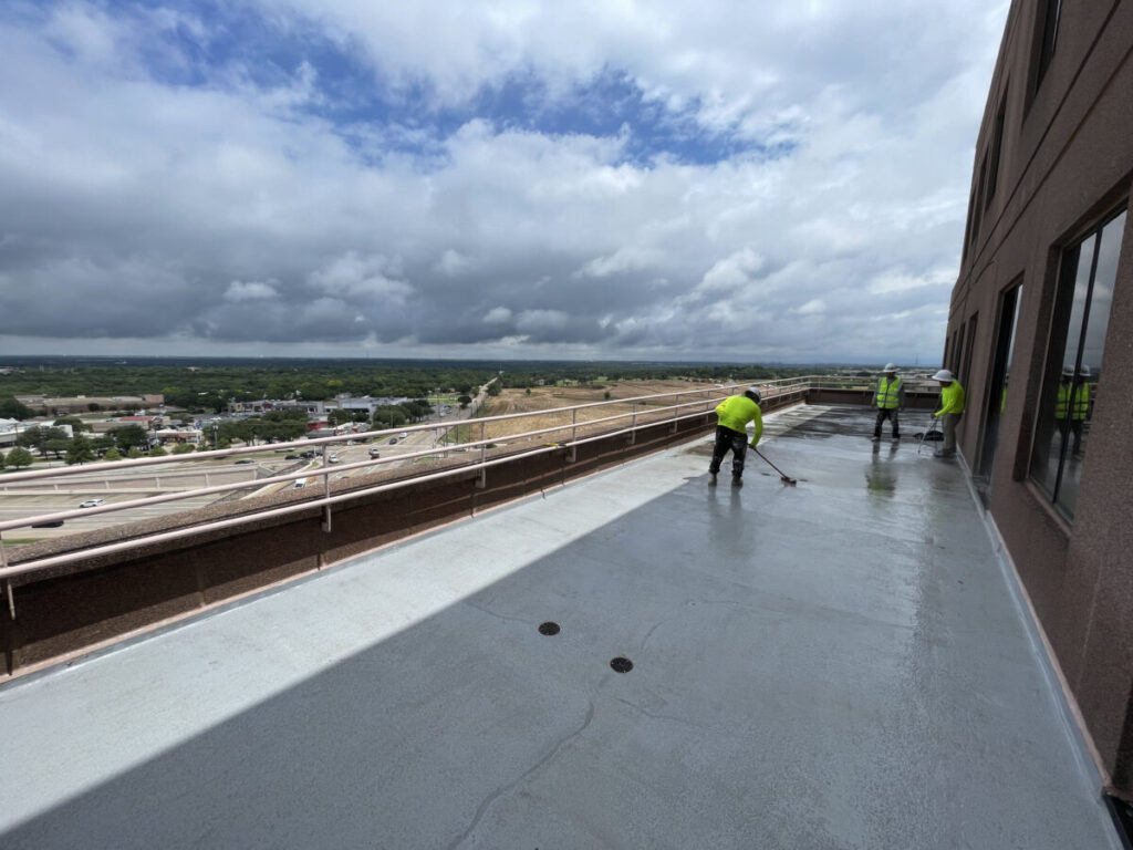 Resurfaced concrete balcony with high-solids silicone coating and ceramic granules on Arlington high-rise by Pepper Coatings