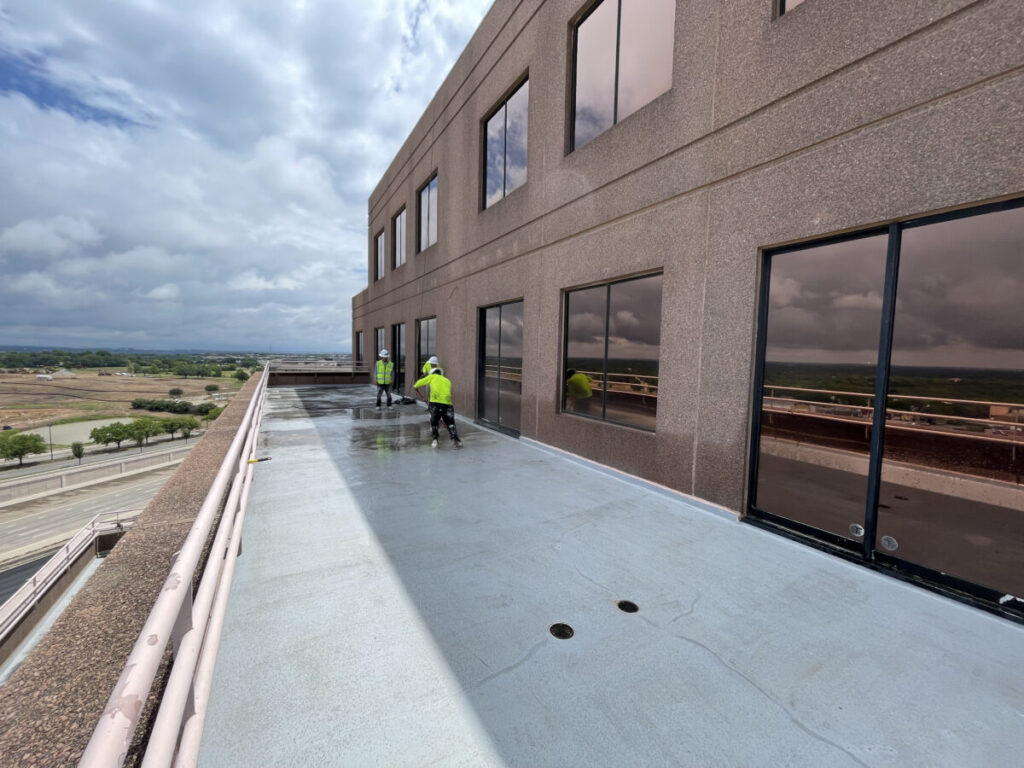 Resurfaced concrete balcony with high-solids silicone coating and ceramic granules on Arlington high-rise by Pepper Coatings