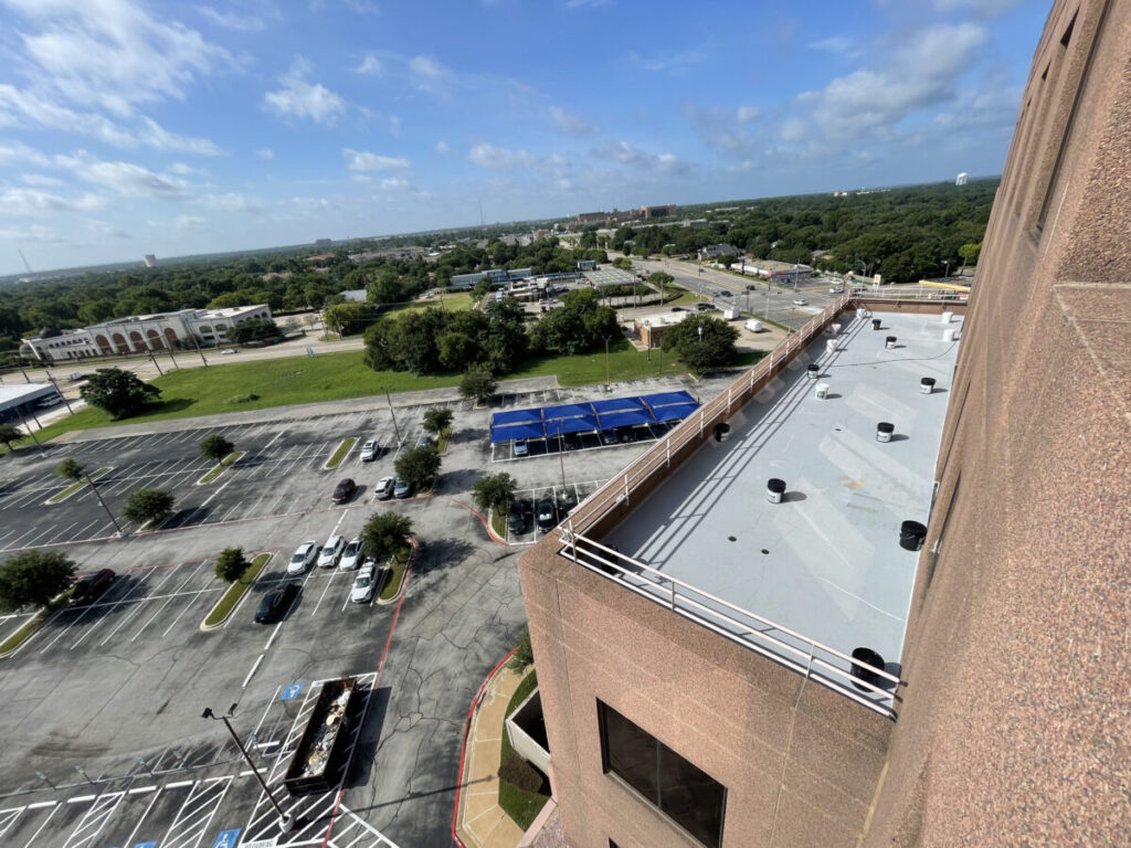 Resurfaced concrete balcony with high-solids silicone coating and ceramic granules on Arlington high-rise by Pepper Coatings