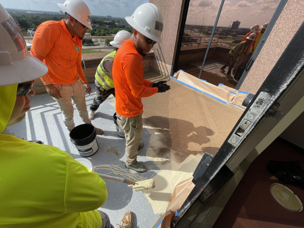 Resurfaced concrete balcony with high-solids silicone coating and ceramic granules on Arlington high-rise by Pepper Coatings
