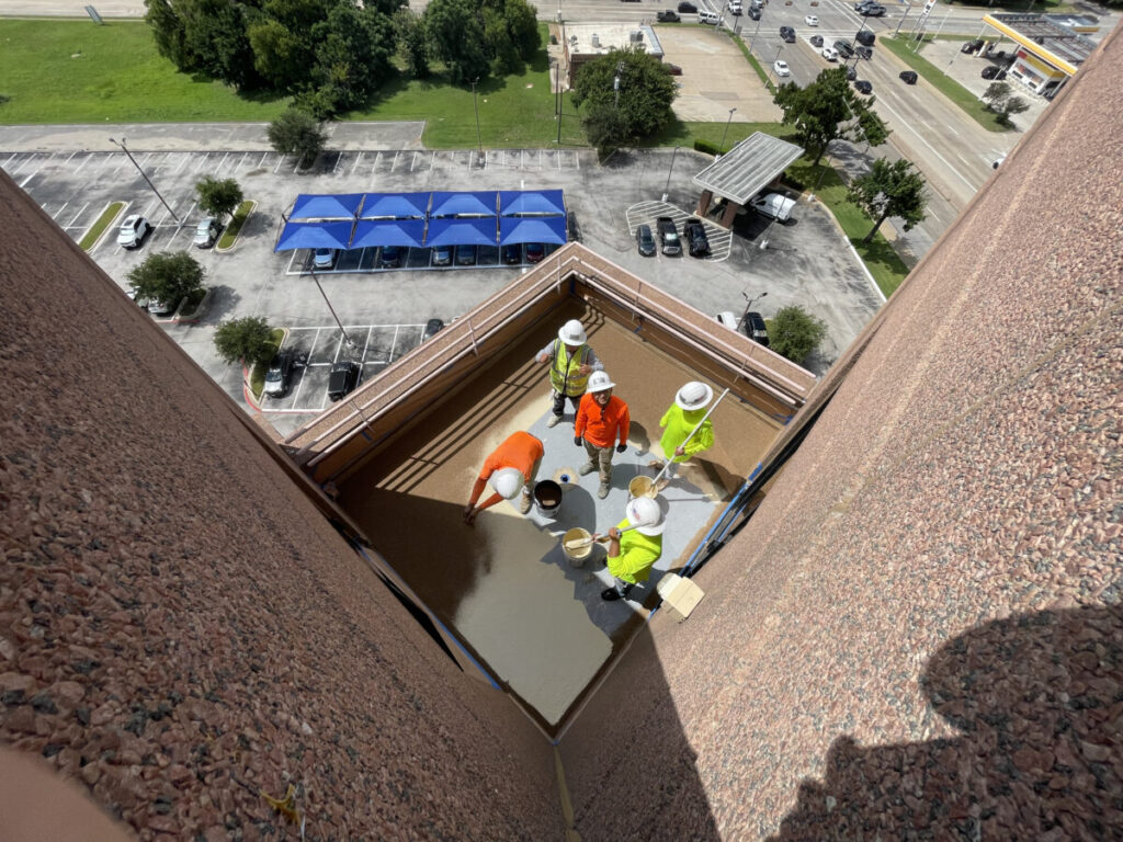 Resurfaced concrete balcony with high-solids silicone coating and ceramic granules on Arlington high-rise by Pepper Coatings
