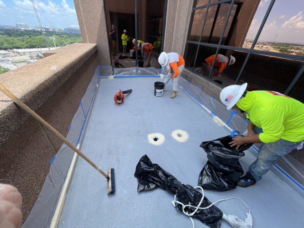 Resurfaced concrete balcony with high-solids silicone coating and ceramic granules on Arlington high-rise by Pepper Coatings