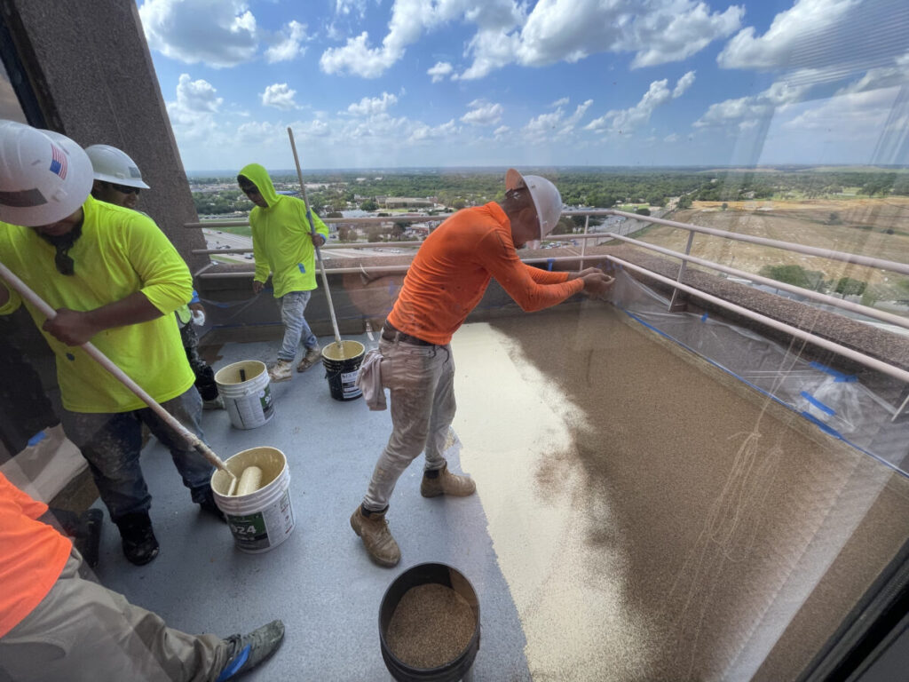 Resurfaced concrete balcony with high-solids silicone coating and ceramic granules on Arlington high-rise by Pepper Coatings