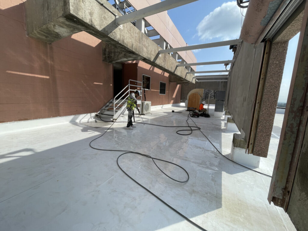 Resurfaced concrete balcony with high-solids silicone coating and ceramic granules on Arlington high-rise by Pepper Coatings