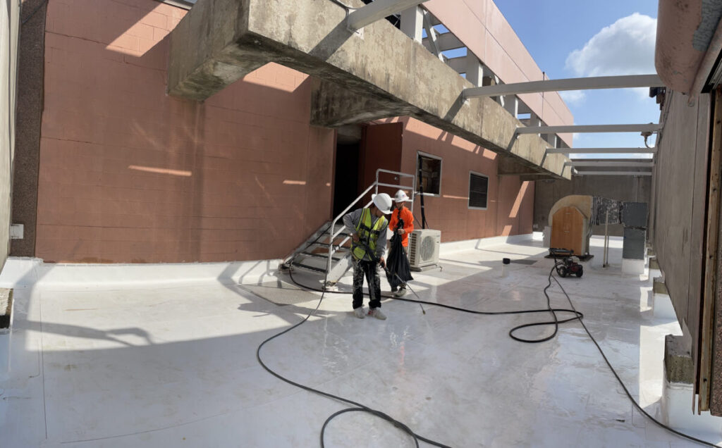Resurfaced concrete balcony with high-solids silicone coating and ceramic granules on Arlington high-rise by Pepper Coatings