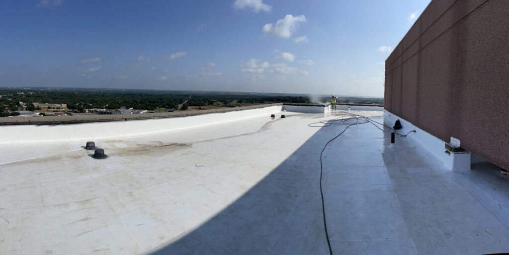 Resurfaced concrete balcony with high-solids silicone coating and ceramic granules on Arlington high-rise by Pepper Coatings