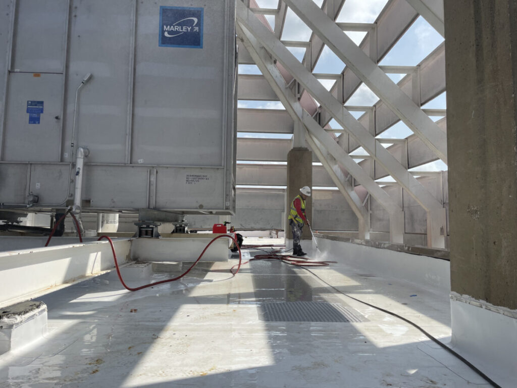 Resurfaced concrete balcony with high-solids silicone coating and ceramic granules on Arlington high-rise by Pepper Coatings