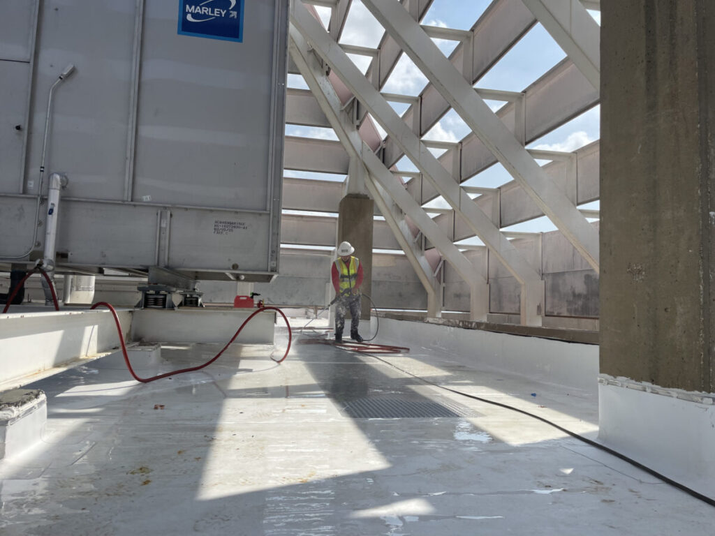 Resurfaced concrete balcony with high-solids silicone coating and ceramic granules on Arlington high-rise by Pepper Coatings