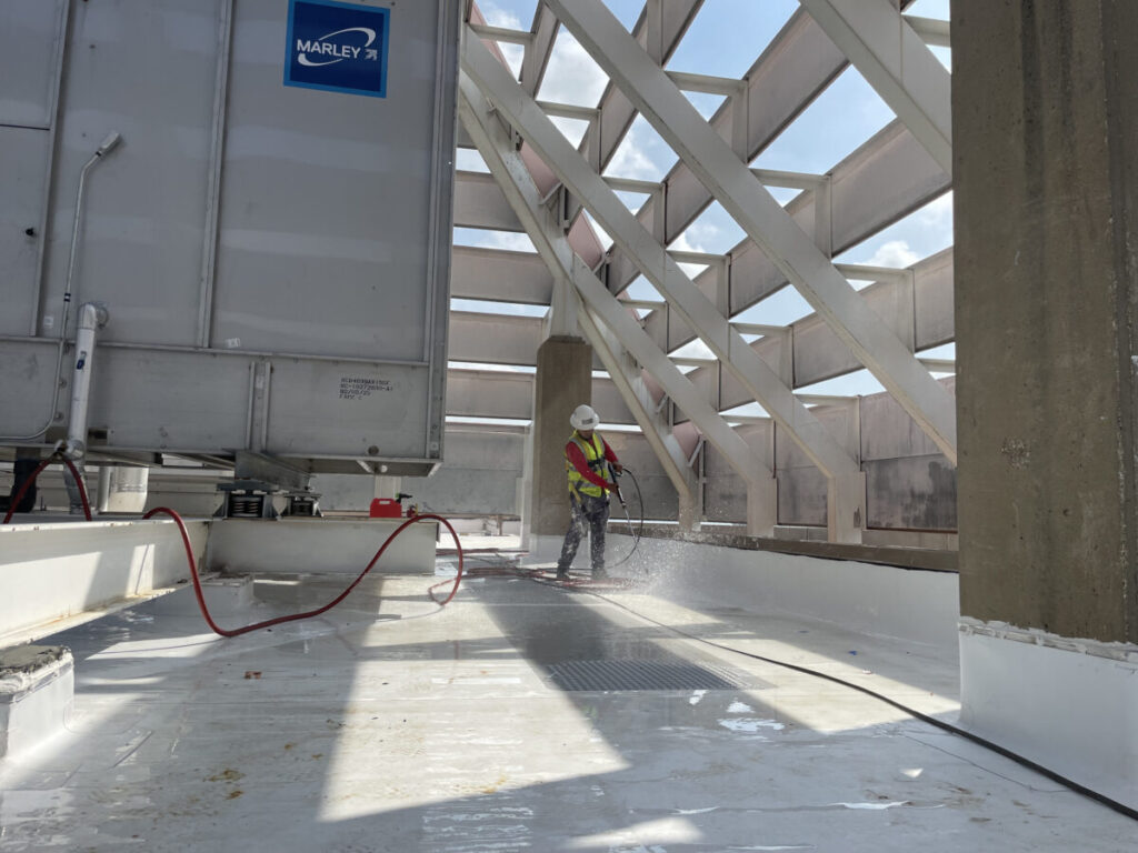 Resurfaced concrete balcony with high-solids silicone coating and ceramic granules on Arlington high-rise by Pepper Coatings