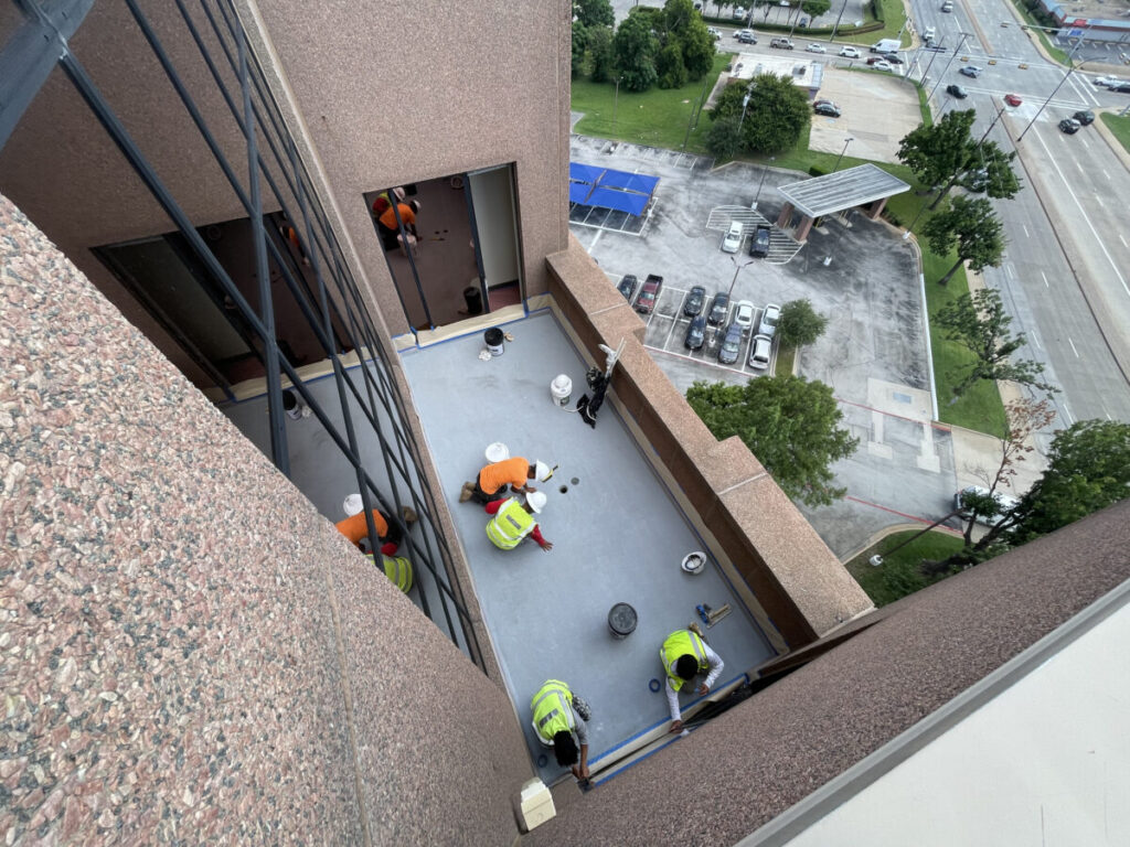 Resurfaced concrete balcony with high-solids silicone coating and ceramic granules on Arlington high-rise by Pepper Coatings