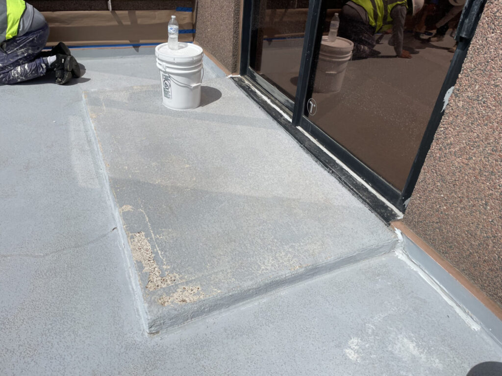 Resurfaced concrete balcony with high-solids silicone coating and ceramic granules on Arlington high-rise by Pepper Coatings