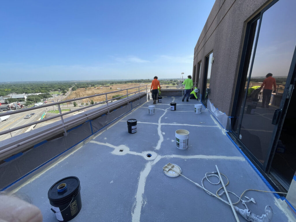 Resurfaced concrete balcony with high-solids silicone coating and ceramic granules on Arlington high-rise by Pepper Coatings