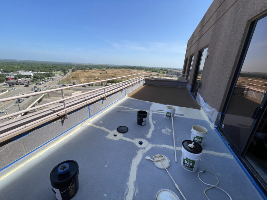 Resurfaced concrete balcony with high-solids silicone coating and ceramic granules on Arlington high-rise by Pepper Coatings