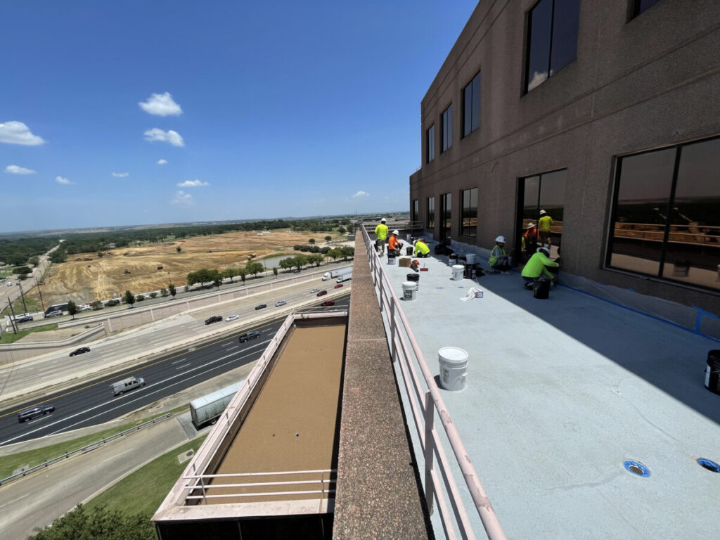 Resurfaced concrete balcony with high-solids silicone coating and ceramic granules on Arlington high-rise by Pepper Coatings