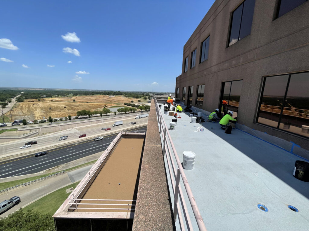 Resurfaced concrete balcony with high-solids silicone coating and ceramic granules on Arlington high-rise by Pepper Coatings