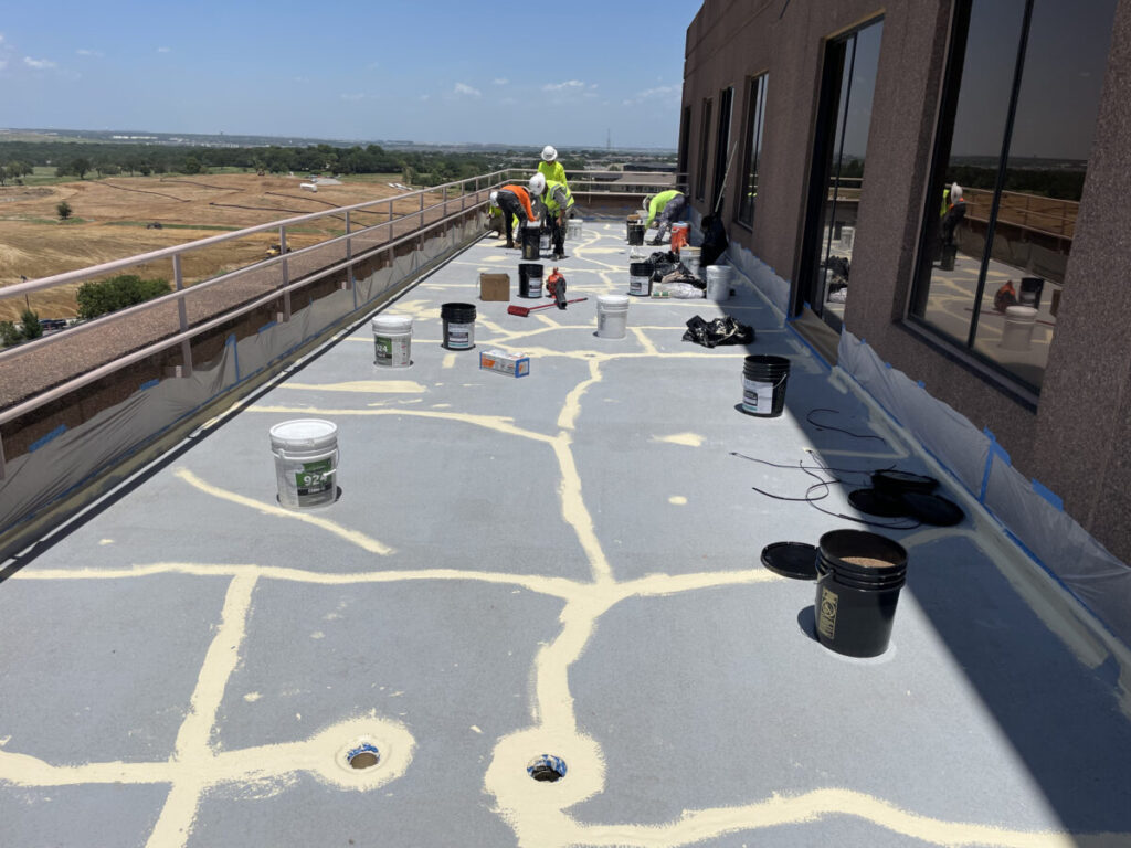 Resurfaced concrete balcony with high-solids silicone coating and ceramic granules on Arlington high-rise by Pepper Coatings