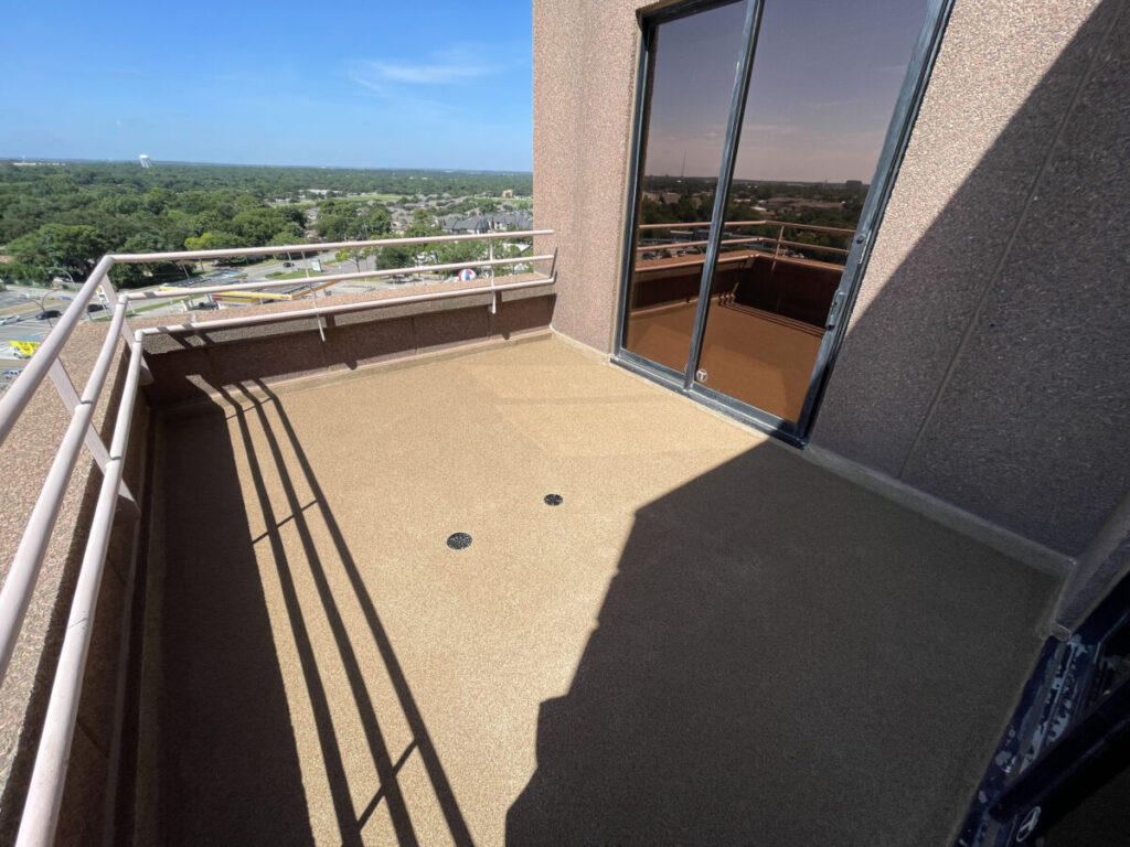 Resurfaced concrete balcony with high-solids silicone coating and ceramic granules on Arlington high-rise by Pepper Coatings