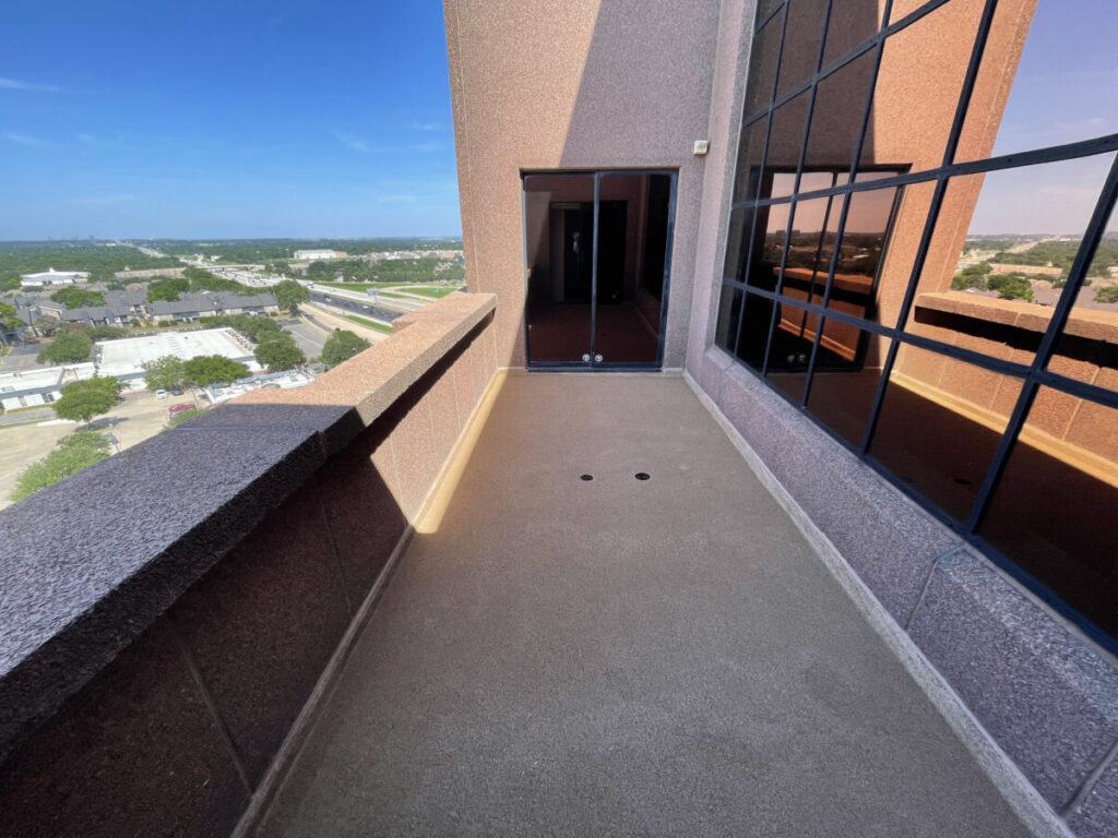 Resurfaced concrete balcony with high-solids silicone coating and ceramic granules on Arlington high-rise by Pepper Coatings