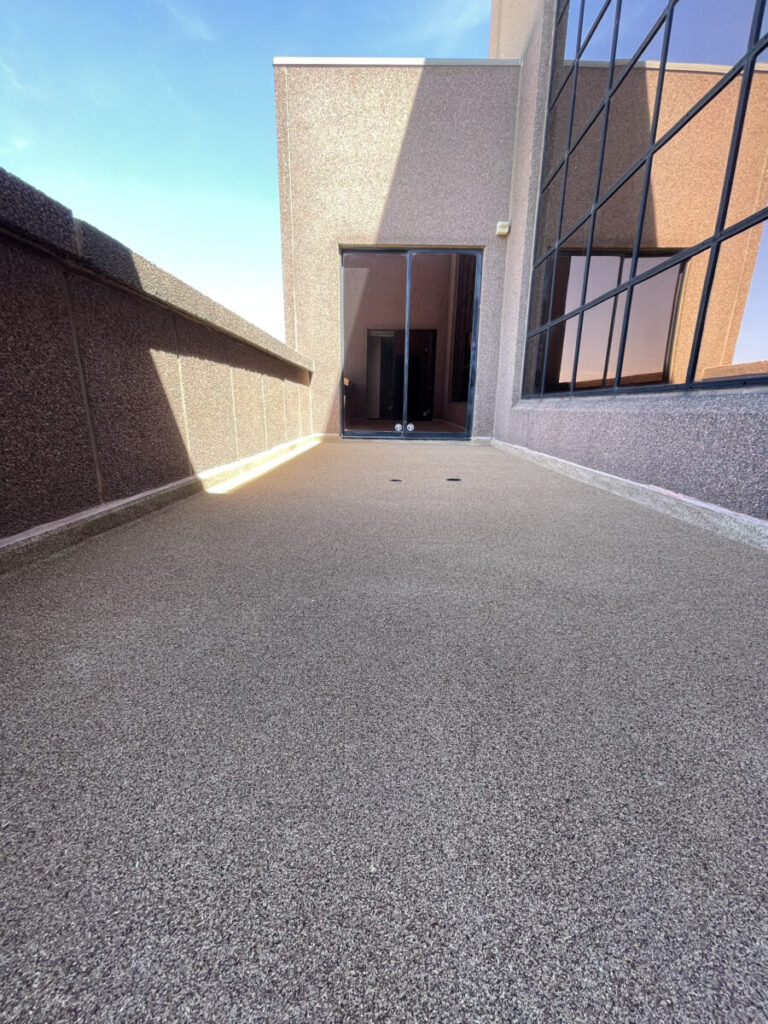 Resurfaced concrete balcony with high-solids silicone coating and ceramic granules on Arlington high-rise by Pepper Coatings