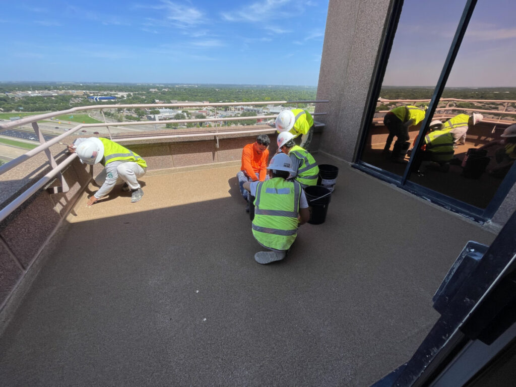 Resurfaced concrete balcony with high-solids silicone coating and ceramic granules on Arlington high-rise by Pepper Coatings