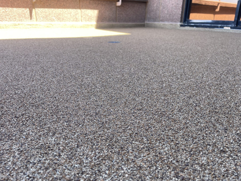 Resurfaced concrete balcony with high-solids silicone coating and ceramic granules on Arlington high-rise by Pepper Coatings