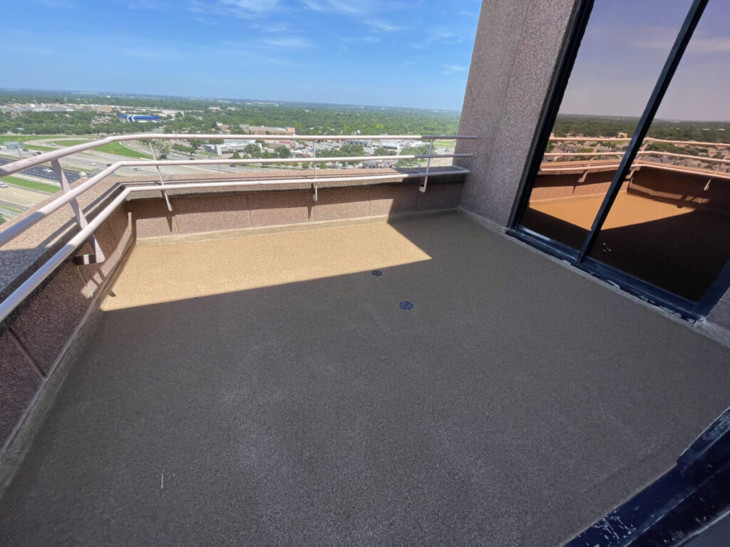 Resurfaced concrete balcony with high-solids silicone coating and ceramic granules on Arlington high-rise by Pepper Coatings