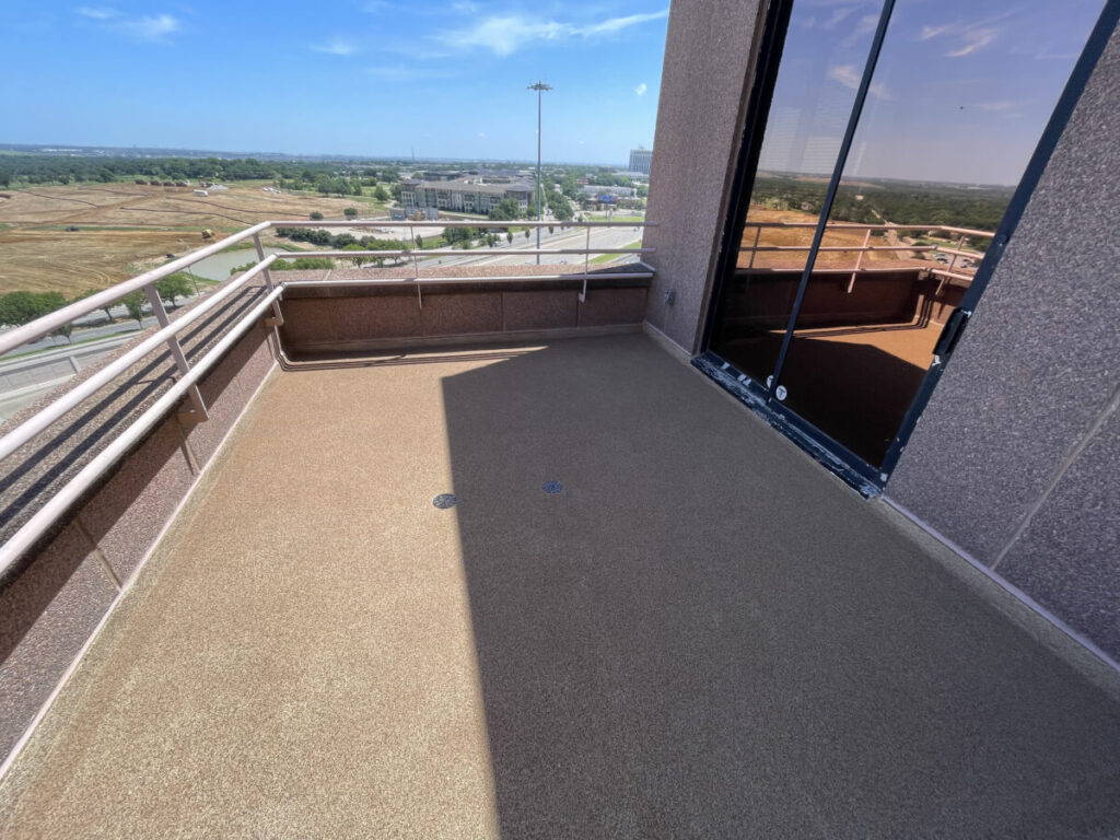 Resurfaced concrete balcony with high-solids silicone coating and ceramic granules on Arlington high-rise by Pepper Coatings