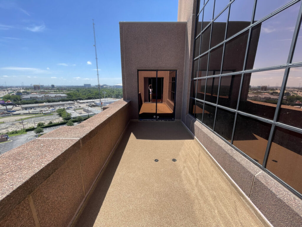Resurfaced concrete balcony with high-solids silicone coating and ceramic granules on Arlington high-rise by Pepper Coatings
