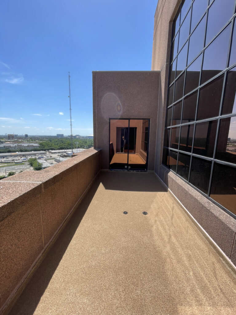 Resurfaced concrete balcony with high-solids silicone coating and ceramic granules on Arlington high-rise by Pepper Coatings