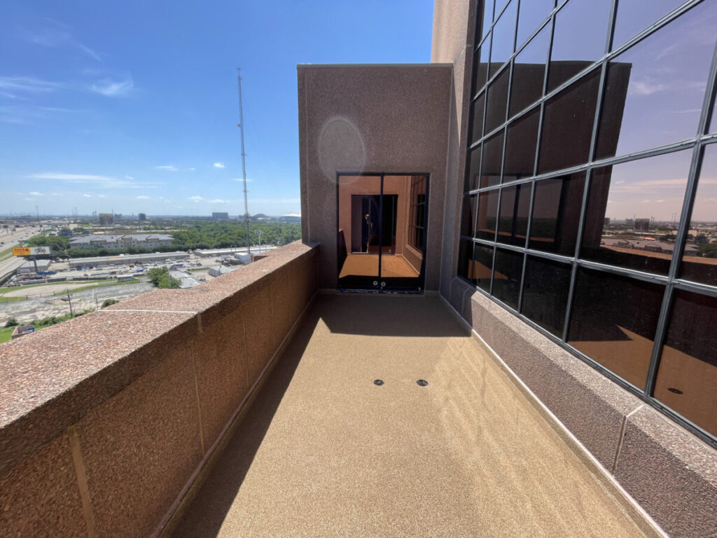 Resurfaced concrete balcony with high-solids silicone coating and ceramic granules on Arlington high-rise by Pepper Coatings