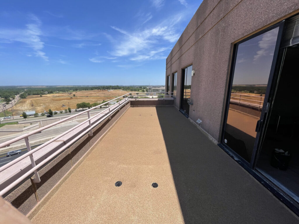Resurfaced concrete balcony with high-solids silicone coating and ceramic granules on Arlington high-rise by Pepper Coatings