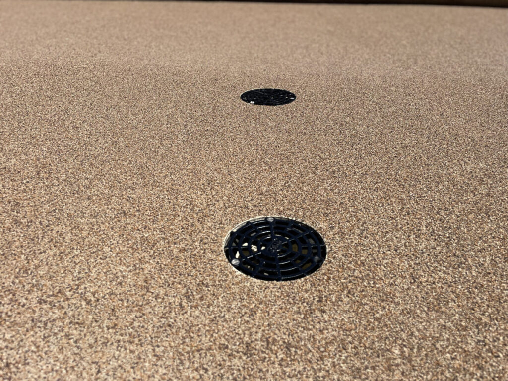 Resurfaced concrete balcony with high-solids silicone coating and ceramic granules on Arlington high-rise by Pepper Coatings