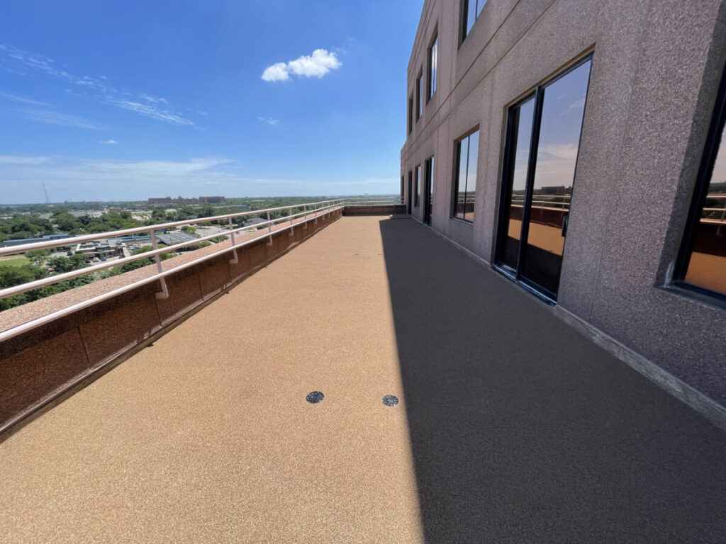Resurfaced concrete balcony with high-solids silicone coating and ceramic granules on Arlington high-rise by Pepper Coatings