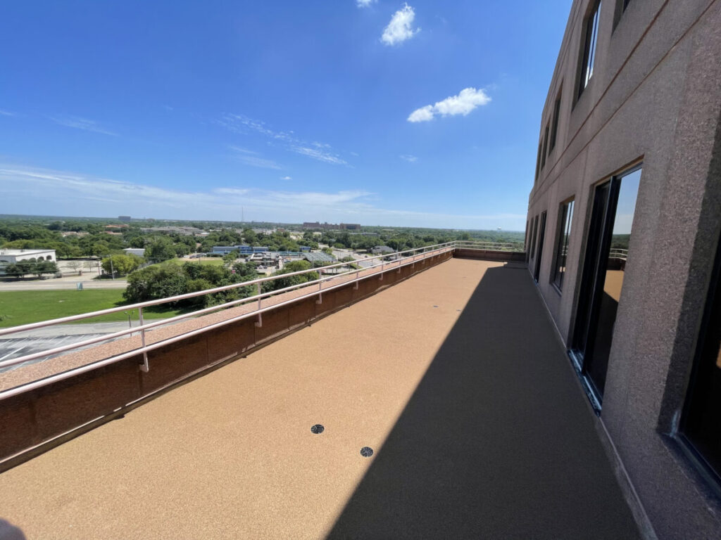 Resurfaced concrete balcony with high-solids silicone coating and ceramic granules on Arlington high-rise by Pepper Coatings
