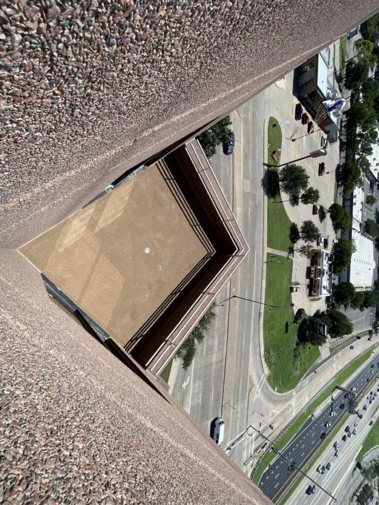 Resurfaced concrete balcony with high-solids silicone coating and ceramic granules on Arlington high-rise by Pepper Coatings