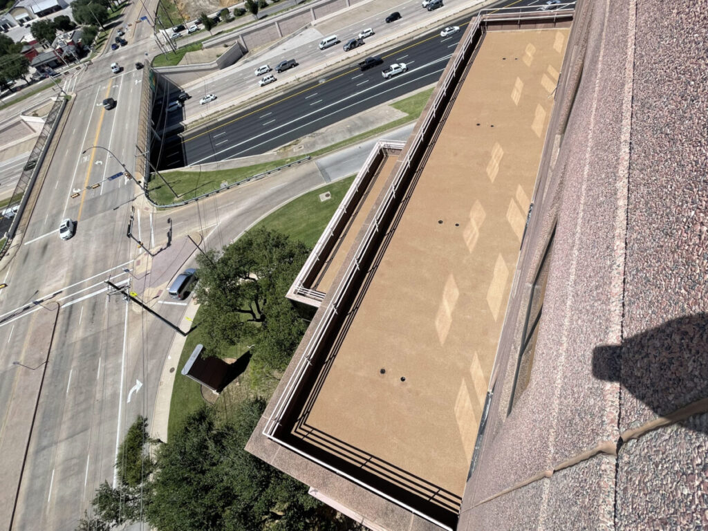 Resurfaced concrete balcony with high-solids silicone coating and ceramic granules on Arlington high-rise by Pepper Coatings