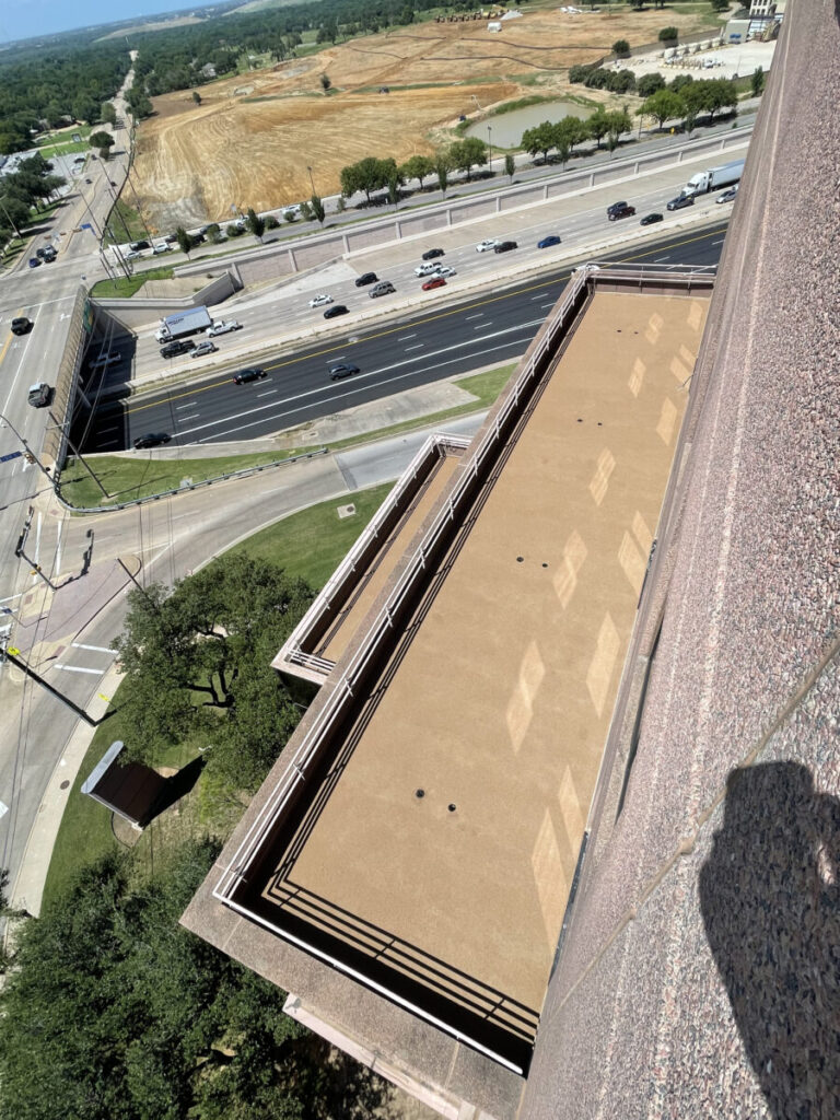 Resurfaced concrete balcony with high-solids silicone coating and ceramic granules on Arlington high-rise by Pepper Coatings