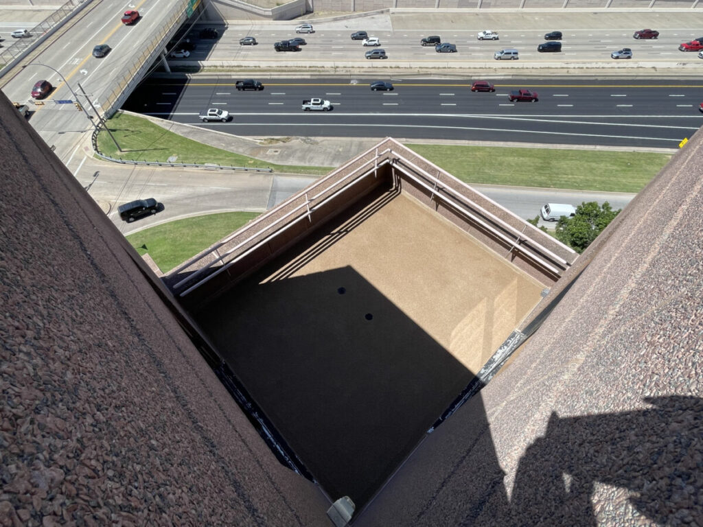 Resurfaced concrete balcony with high-solids silicone coating and ceramic granules on Arlington high-rise by Pepper Coatings