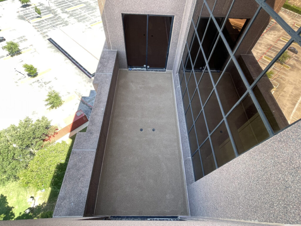 Resurfaced concrete balcony with high-solids silicone coating and ceramic granules on Arlington high-rise by Pepper Coatings