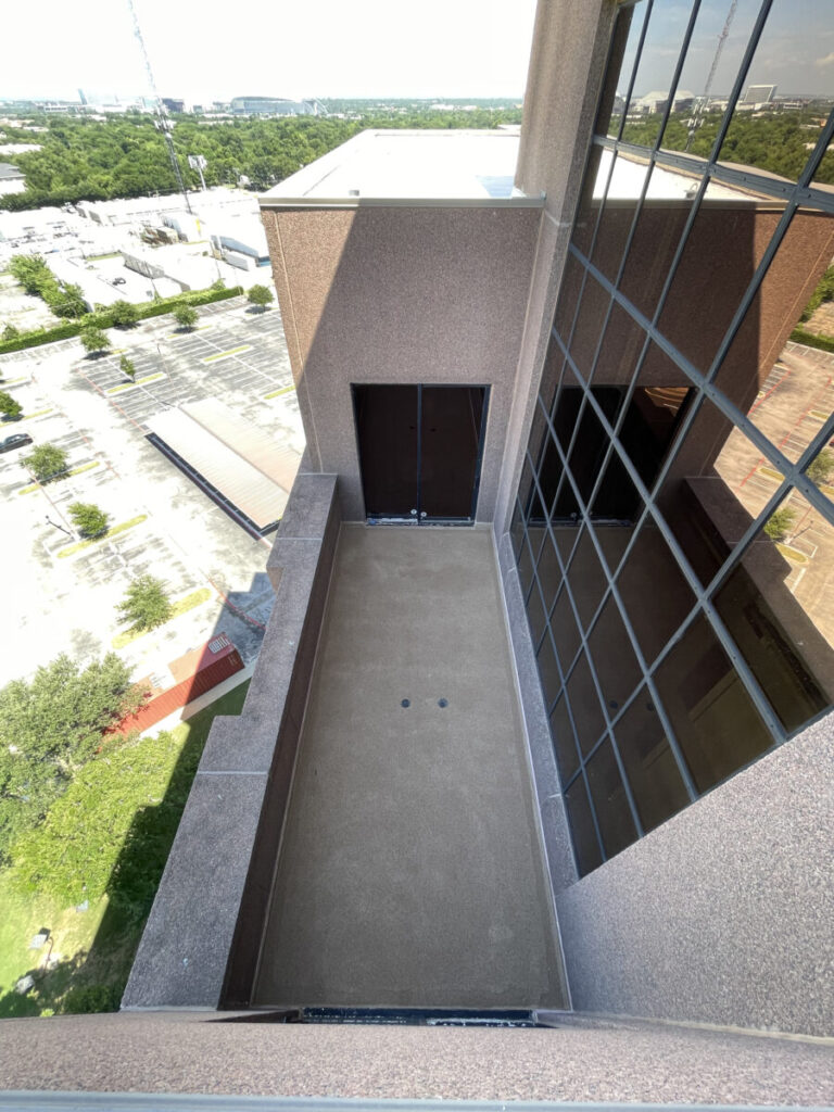 Resurfaced concrete balcony with high-solids silicone coating and ceramic granules on Arlington high-rise by Pepper Coatings