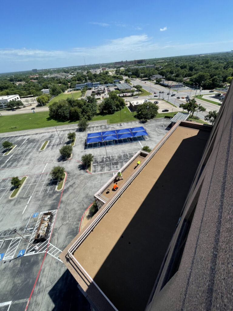 Resurfaced concrete balcony with high-solids silicone coating and ceramic granules on Arlington high-rise by Pepper Coatings