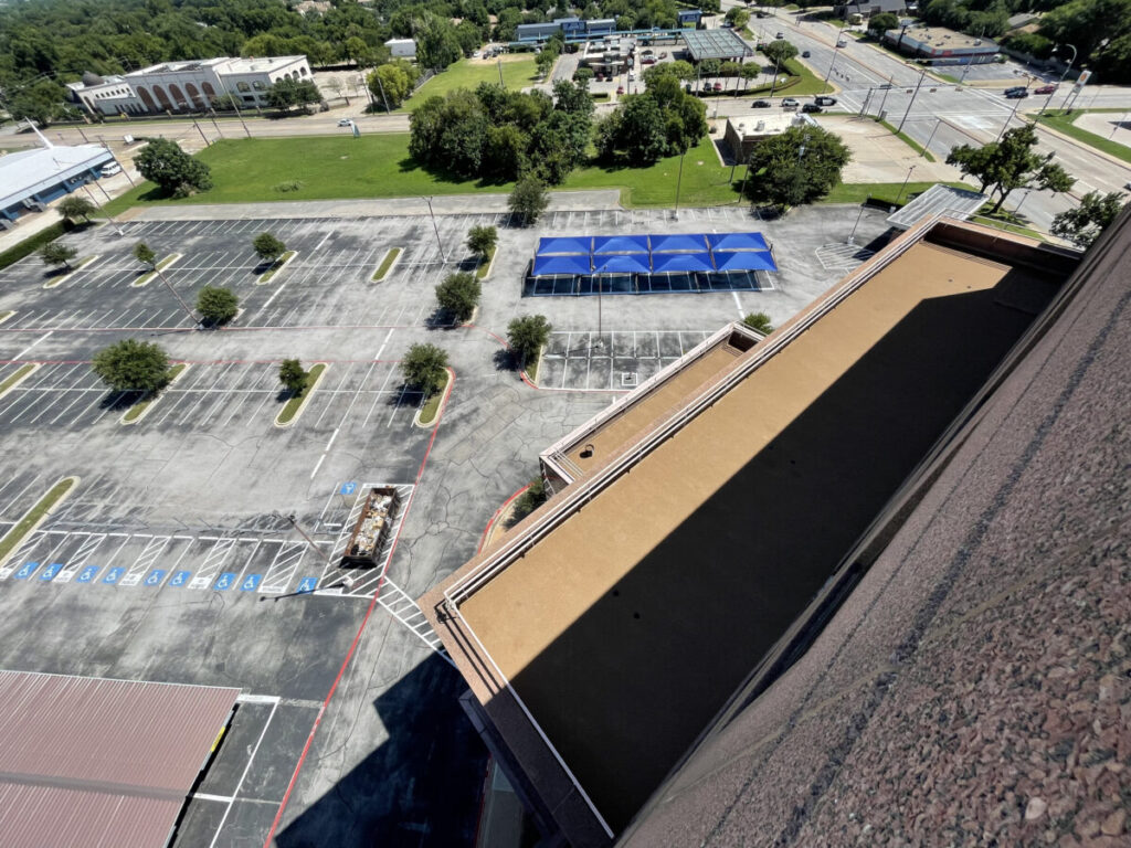 Resurfaced concrete balcony with high-solids silicone coating and ceramic granules on Arlington high-rise by Pepper Coatings