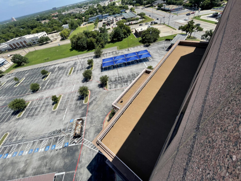 Resurfaced concrete balcony with high-solids silicone coating and ceramic granules on Arlington high-rise by Pepper Coatings