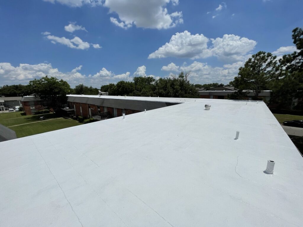 Completed white silicone roof coating on the Arlington multifamily apartment complex