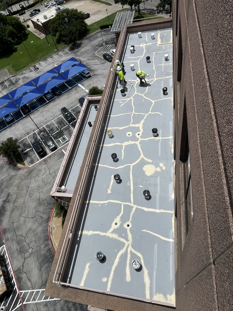 Concrete balcony deck prepped with heavy silicone mastic at Skymark Tower, Arlington