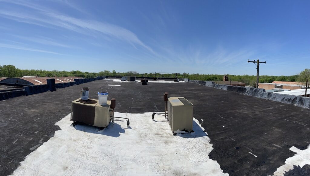 Silicone mastic applied at parapet wall cracking and roof deficiencies in Bonham, Texas