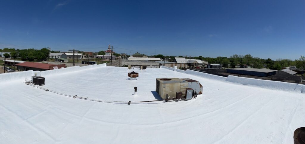 Completed silicone roof coating restoration at 170 N Center St in Fannin County, Bonham, TX