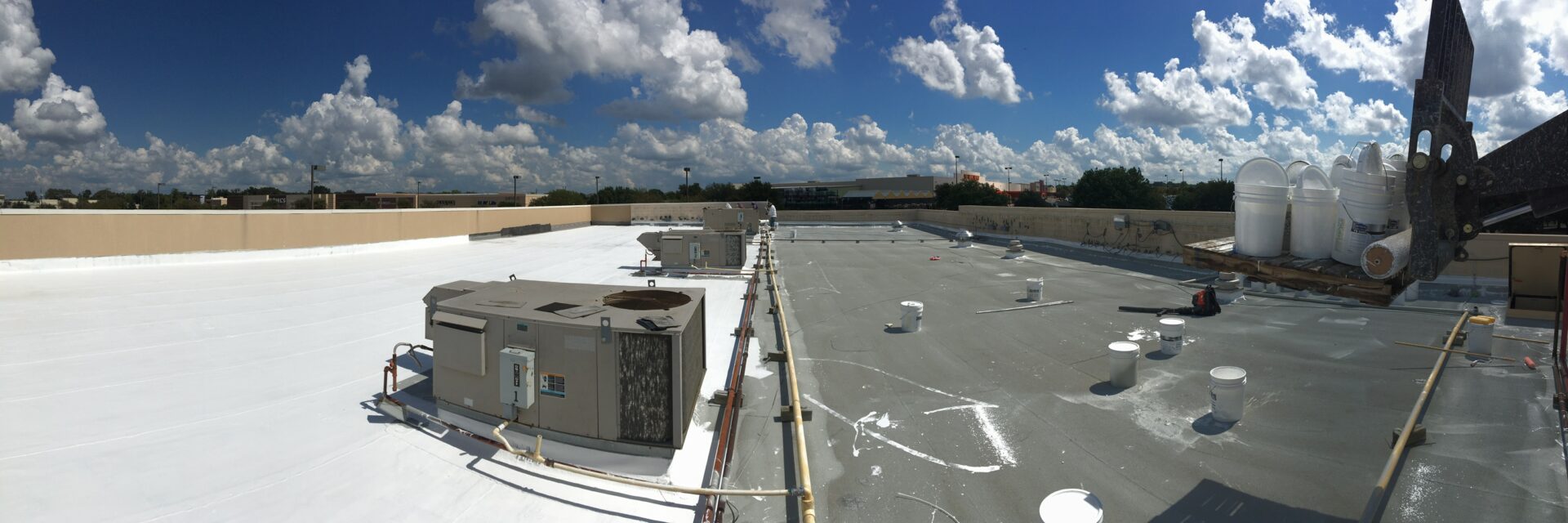 Silicone roof coating installation in progress at Cedar Hill Crossing retail center in Cedar Hill, TX